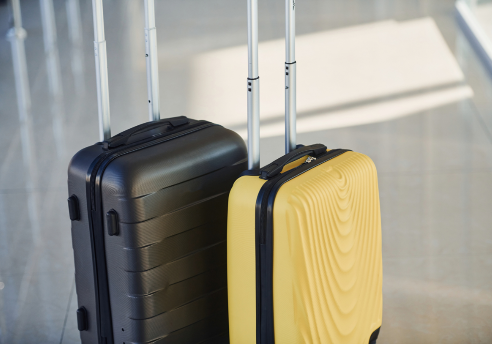 Uniformed handler collecting a sealed parcel at a doorstep for TransBaggage
